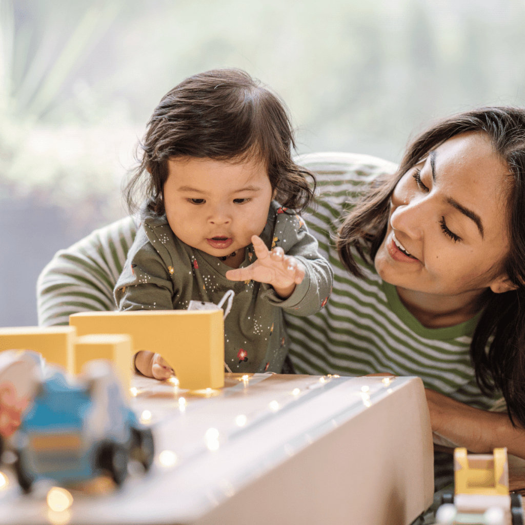 toddler girl playing with a wooden block