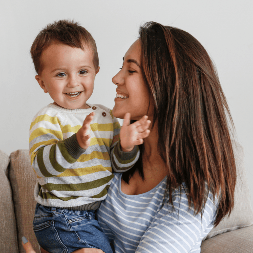 Mom with toddler boy clapping